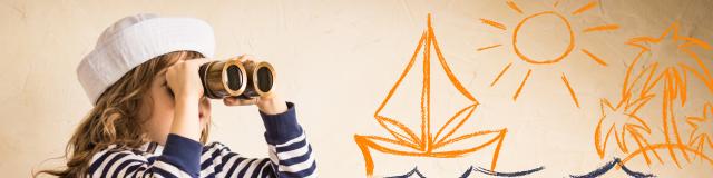 Happy kid playing with toy sailing boat indoors. Travel and adventure concept